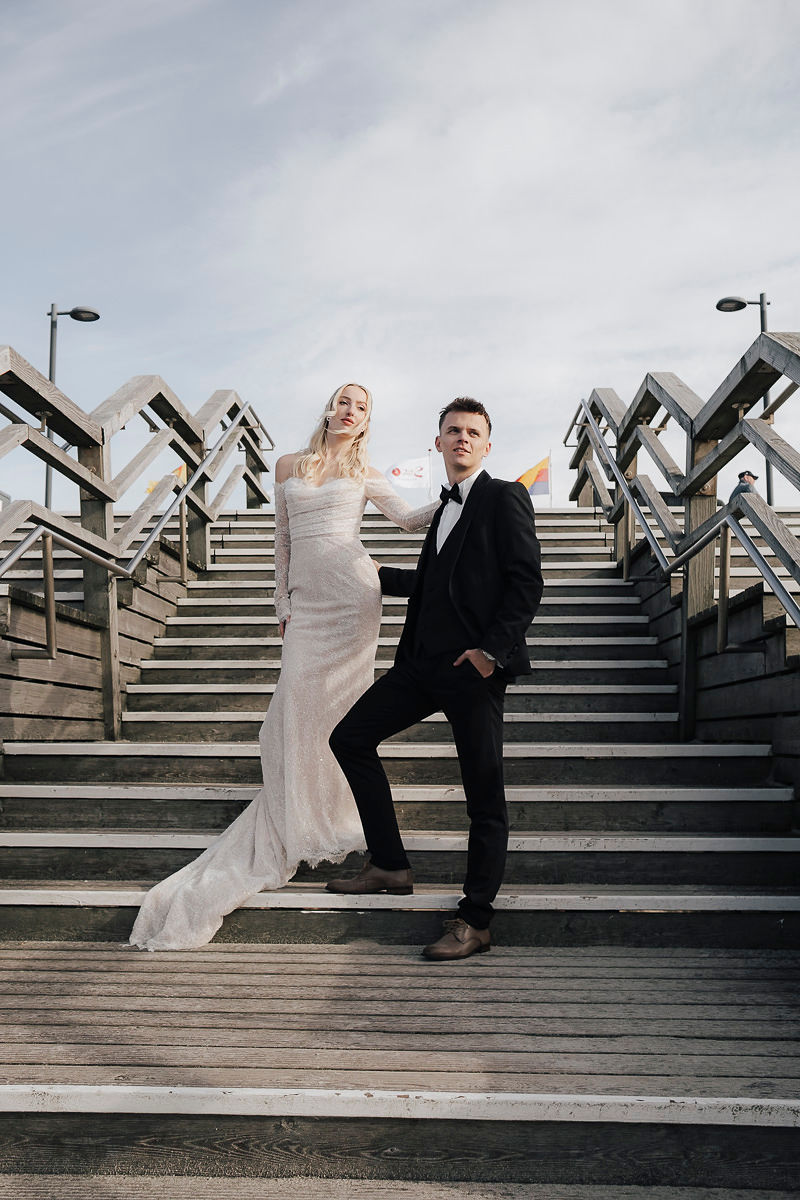 Brautpaar auf der Holztreppe zum Strand von Sylt